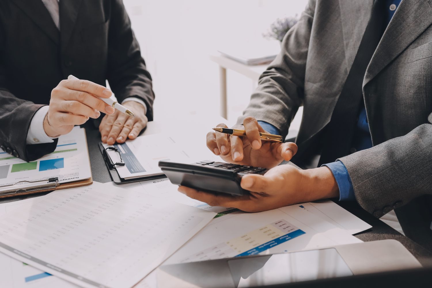 Office professionals meeting at a table with papers image