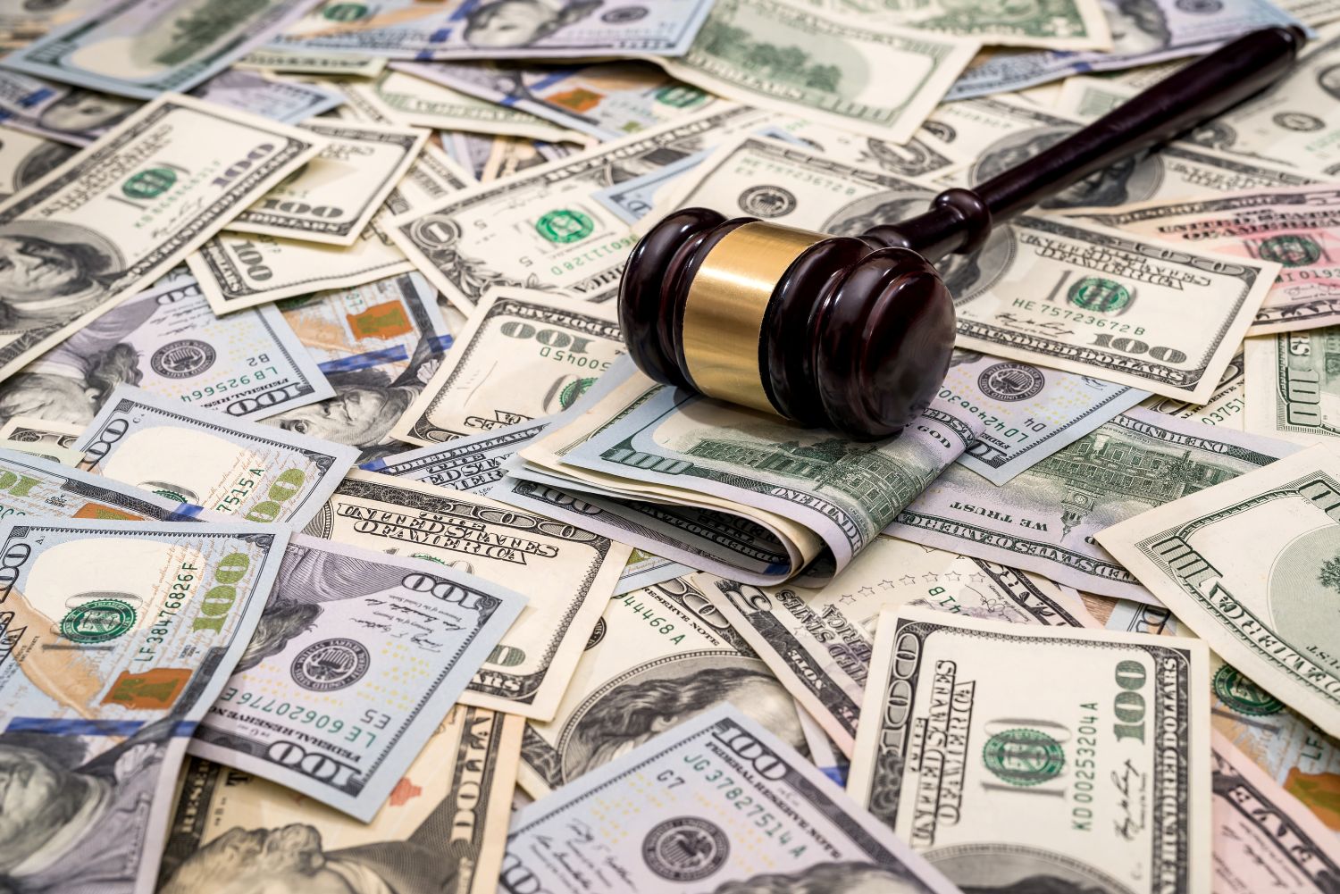 Gavel sitting on a spread of cash image