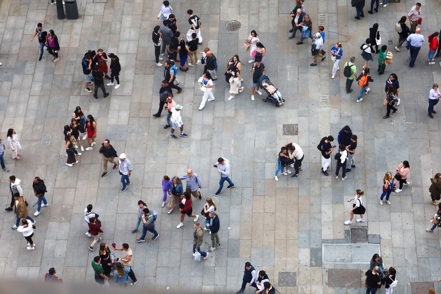Overhead angle of people walking in a city square image