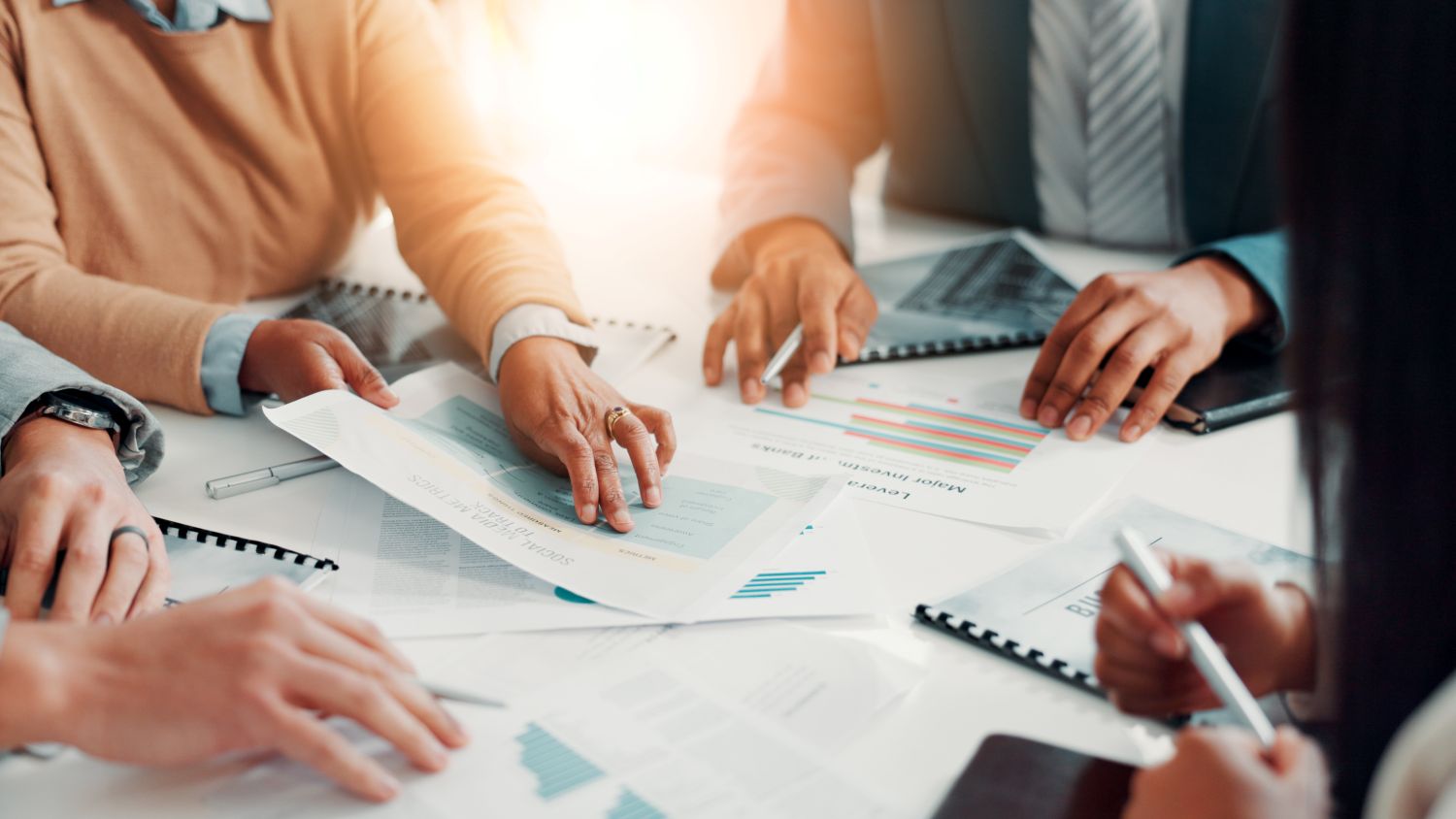 Four office professionals meeting at a table with papers image