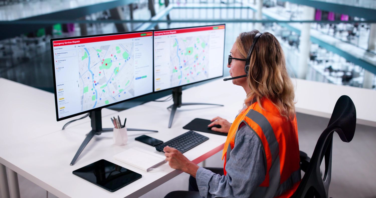 Dispatcher working at two monitors image